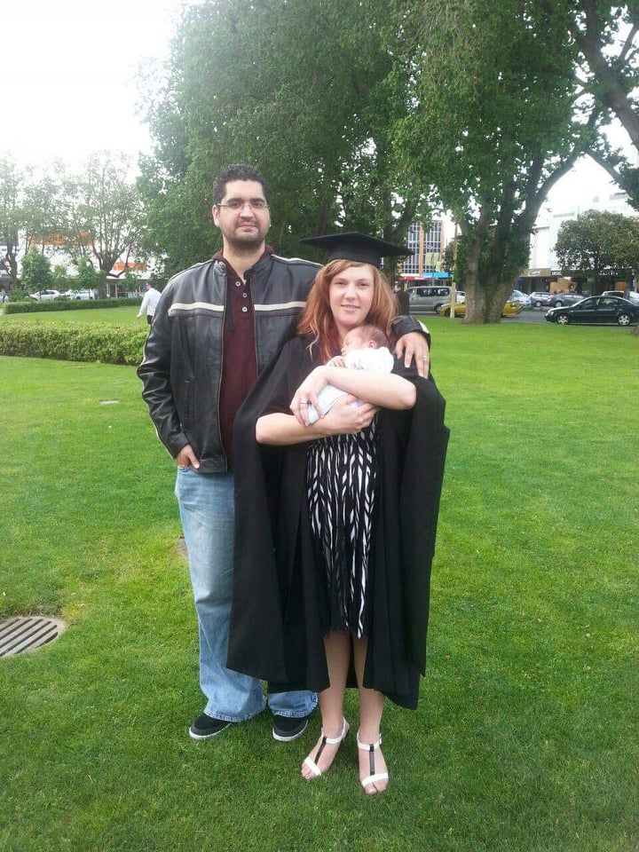 Lainey Graduation with husband and new born son, Andre by her side